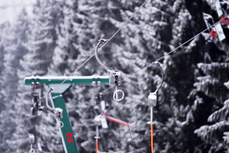 Empty ski lift cable in a ski resort during snowfallの写真素材