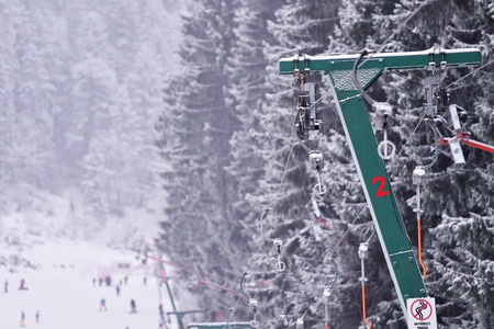 Empty ski lift cable in a ski resort during snowfallの写真素材