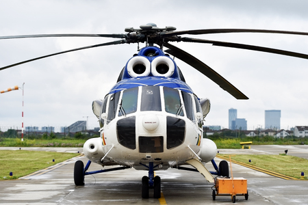 Detail with helicopter fuselage and rotor blade system on runwayの写真素材
