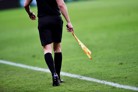 Assistant referee moving along the sideline during a soccer matchの写真素材