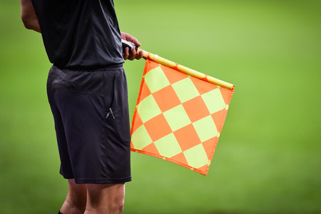 Assistant referee moving along the sideline during a soccer matchの写真素材