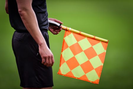 Assistant referee moving along the sideline during a soccer matchの写真素材