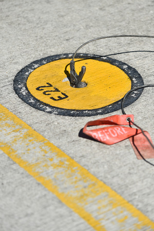 Static grounding clamps connected on an airplane on the runwayの写真素材