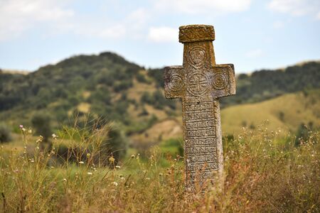 Ancient stone orthodox cross deserted on a plainの写真素材