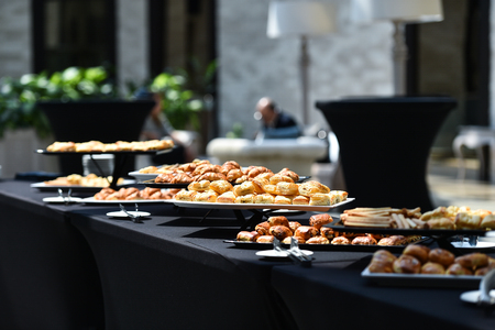Table full with fresh pastry products during eventの写真素材
