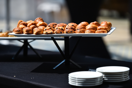 Table full with fresh pastry products during eventの写真素材