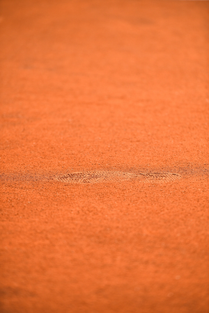 Detail with sport shoe footprints on a tennis clay courtの写真素材
