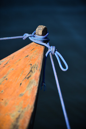 Wooden canoe roped up to the shoreの写真素材