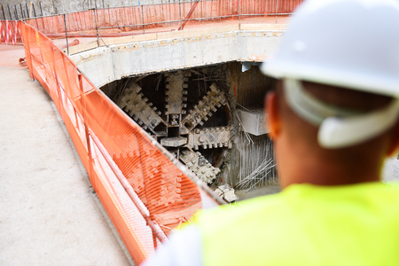 Workers inspecting construction works on a scaffold inside construction siteの写真素材