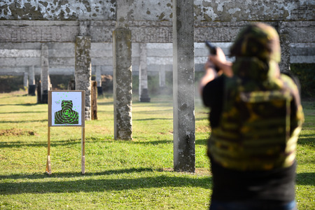 Outdoor shooting with a 9mm pistol in a shooting rangeの写真素材