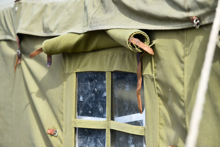 Detail with the exterior of a green military tentの写真素材
