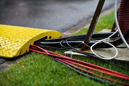 Closeup shot during heavy rain on industrial electric cablesの写真素材