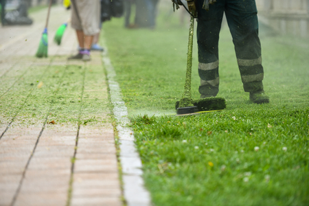 Law mower man trimming grass in the cityの写真素材