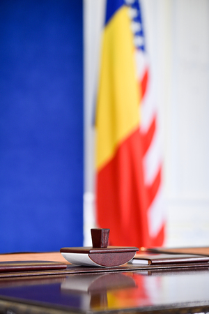 Concept shot with a stamp and flags in the background after treaty signの写真素材