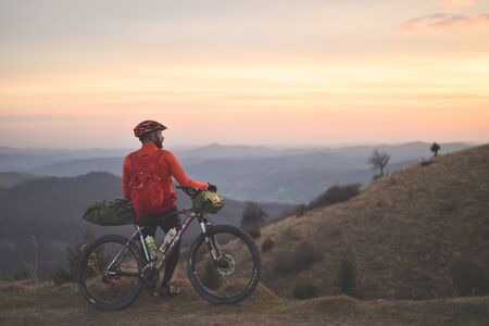 PRAHOVA/ROMANIA - OCTOBER 28, 2018: Autumn mountain scene riding with a mountain bike equipped with travel bags.のeditorial素材