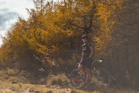 PRAHOVA/ROMANIA - OCTOBER 28, 2018: Autumn mountain scene riding with a mountain bike equipped with travel bags.のeditorial素材