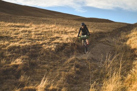 PRAHOVA/ROMANIA - OCTOBER 28, 2018: Autumn mountain scene riding with a mountain bike equipped with travel bags.のeditorial素材