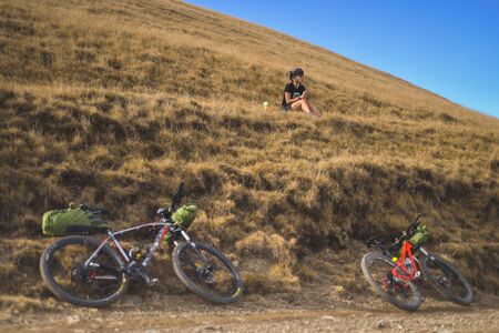 PRAHOVA/ROMANIA - OCTOBER 28, 2018: Autumn mountain scene riding with a mountain bike equipped with travel bags.のeditorial素材