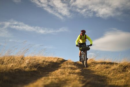 PRAHOVA/ROMANIA - OCTOBER 28, 2018: Autumn mountain scene riding with a mountain bike equipped with...