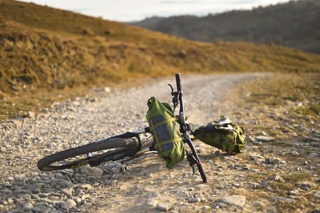 Autumn mountain scene riding with a mountain bike equipped with travel bags.の写真素材