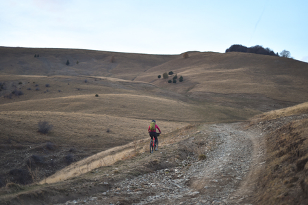 Autumn mountain scene riding with a mountain bike equipped with travel bags.の写真素材