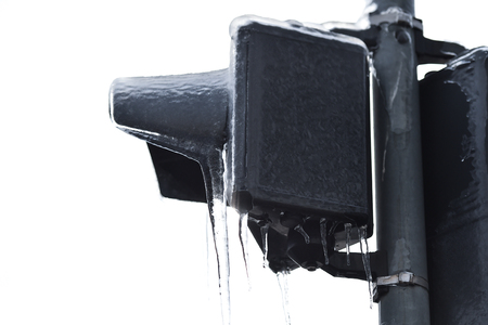 Street traffic lights covered in ice after frozen rain phenomenonの写真素材