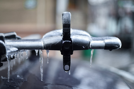 Bicycle rack on a car covered in ice after frozen rain phenomenonの写真素材