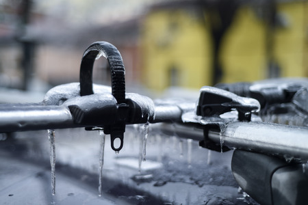 Bicycle rack on a car covered in ice after frozen rain phenomenonの写真素材