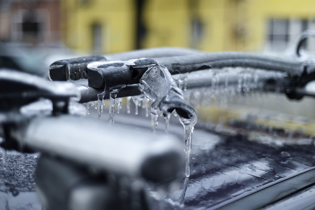 Bicycle rack on a car covered in ice after frozen rain phenomenonの写真素材