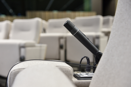 Detail shot with a press microphone in a conference roomの写真素材