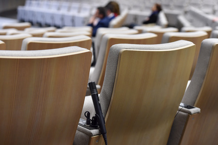 Detail shot with a press microphone in a conference roomの写真素材