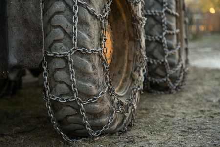 Photo detail with snow tire chains on big truck wheelの写真素材