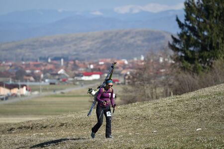 ZARNESTI, ROMANIA - MARCH 30, 2019: Athletes compete during a spring ski touring and trail running competition in Piatra Craiului mountains.のeditorial素材