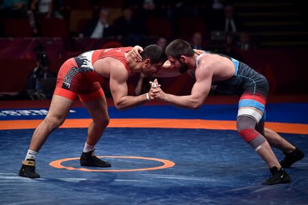 BUCHAREST, ROMANIA - APRIL 10, 2019: Taha Akgul from Turkey, competes against Geno Petriashvili, from Georgia, during the European Wrestling Championship in Bucharest.のeditorial素材