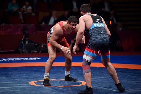 BUCHAREST, ROMANIA - APRIL 10, 2019: Taha Akgul from Turkey, competes against Geno Petriashvili, from Georgia, during the European Wrestling Championship in Bucharest.のeditorial素材