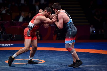 BUCHAREST, ROMANIA - APRIL 10, 2019: Taha Akgul from Turkey, competes against Geno Petriashvili, from Georgia, during the European Wrestling Championship in Bucharest.のeditorial素材