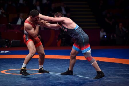 BUCHAREST, ROMANIA - APRIL 10, 2019: Taha Akgul from Turkey, competes against Geno Petriashvili, from Georgia, during the European Wrestling Championship in Bucharest.のeditorial素材