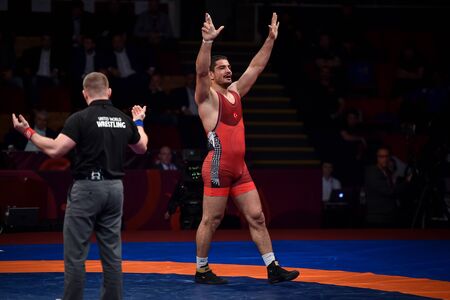 BUCHAREST, ROMANIA - APRIL 10, 2019: Taha Akgul from Turkey, competes against Geno Petriashvili, from Georgia, during the European Wrestling Championship in Bucharest.のeditorial素材