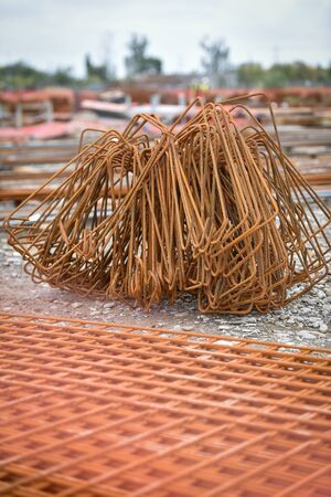 Detail with reinforcing iron bars on a construction site. Construction workers on the background.の写真素材