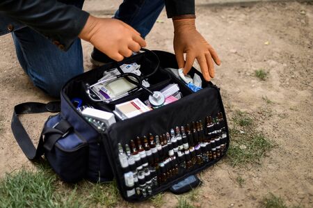 Paramedics providing first aid assistance to a collapsed person presenting a head injury の写真素材