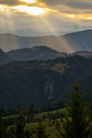 Hills, forests and meadows in Transylvania Bran county at sunset on a beautiful summer dayの写真素材