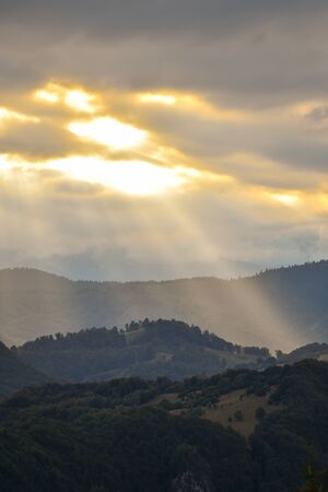 Hills, forests and meadows in Transylvania Bran county at sunset on a beautiful summer dayの写真素材