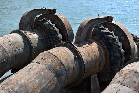 Industrial pipes used to pump water from a river to irrigate drought fieldsの写真素材