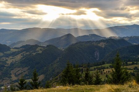 Hills, forests and meadows in Transylvania Bran county at sunset on a beautiful summer dayの写真素材