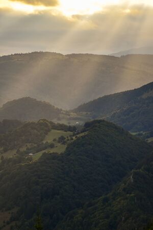 Hills, forests and meadows in Transylvania Bran county at sunset on a beautiful summer dayの写真素材