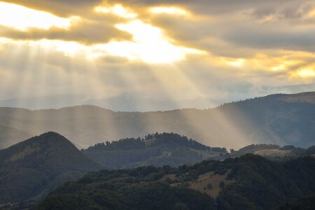Hills, forests and meadows in Transylvania Bran county at sunset on a beautiful summer dayの写真素材