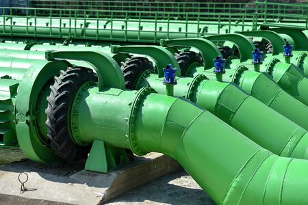Industrial pipes used to pump water from a river to irrigate drought fieldsの写真素材
