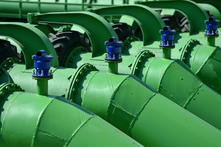 Industrial pipes used to pump water from a river to irrigate drought fieldsの写真素材