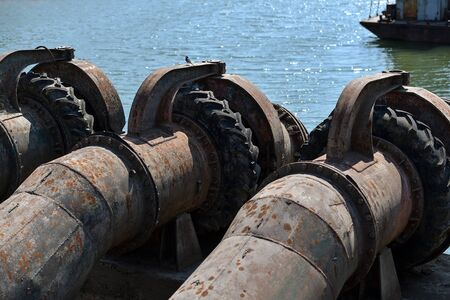 Industrial pipes used to pump water from a river to irrigate drought fieldsの写真素材