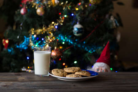 Father Christmas toy watching the cookies and the glass of milk.の写真素材